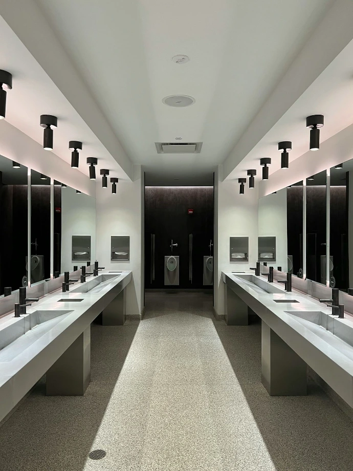 a large bathroom with sinks and mirrors